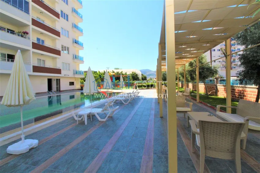 Квартира в Махмутларе с мебелью, застекленным балконом в благоустроенной резиденции 10 