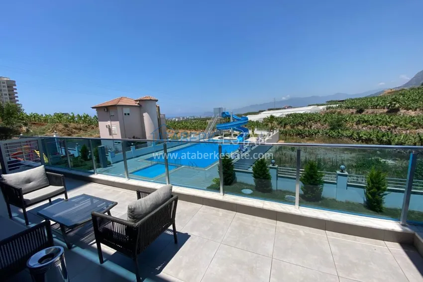 Приобрести Квартира в Махмутларе с новой мебелью в молодом комфортабельном комплексе 12 