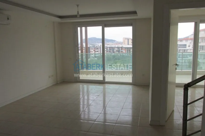 Приобрести Квартира-дуплекс в районе Оба в комфортабельном семейном жилом комплексе  2 