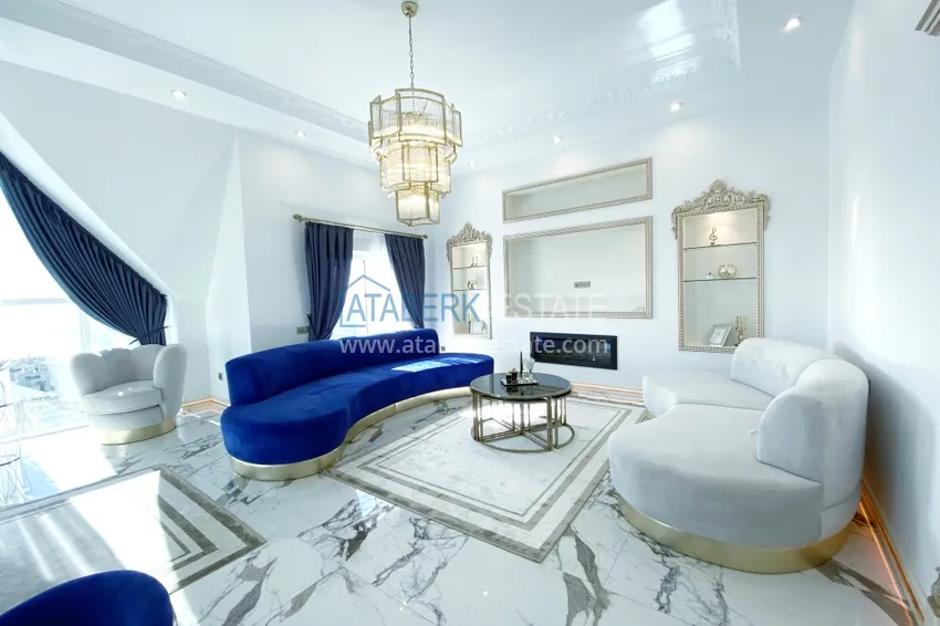 Приобрести Видовой двухуровневый пентхаус с авторским интерьером в районе Махмутлар 12 