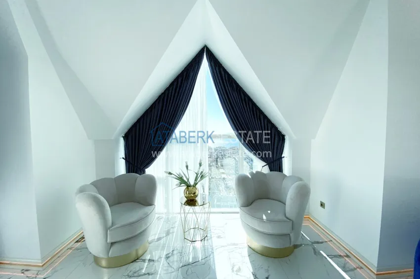 Приобрести Видовой двухуровневый пентхаус с авторским интерьером в районе Махмутлар 13 