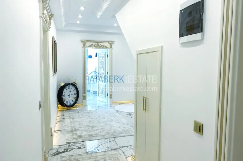 Приобрести Видовой двухуровневый пентхаус с авторским интерьером в районе Махмутлар 21 