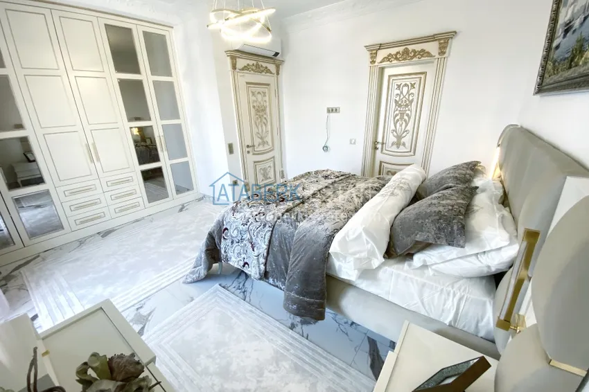 Приобрести Видовой двухуровневый пентхаус с авторским интерьером в районе Махмутлар 46 