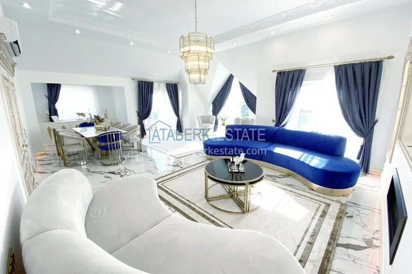 Приобрести Видовой двухуровневый пентхаус с авторским интерьером в районе Махмутлар 4 