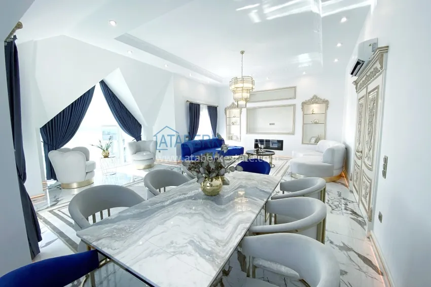 Приобрести Видовой двухуровневый пентхаус с авторским интерьером в районе Махмутлар 8 