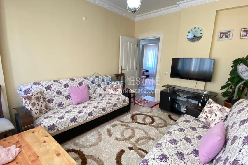 Приобрести Квартира в Махмутларе с мебелью и видом на горы с хорошо продуманной планировкой в комплексе городского типа 17 