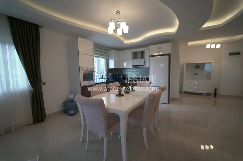 Приобрести Дуплекс в Махмутларе с мебелью и застекленным балконом в благоустроенной резиденции 10 