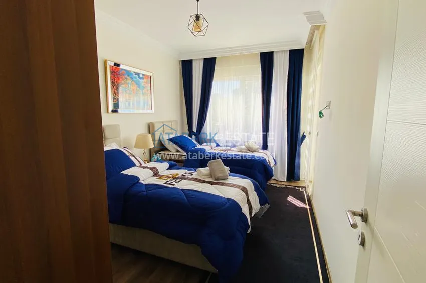 Приобрести Квартира в Махмутларе меблированная с отдельной кухней и видом на горы располагает собственной охраняемой территорией с инфраструктурой 15 