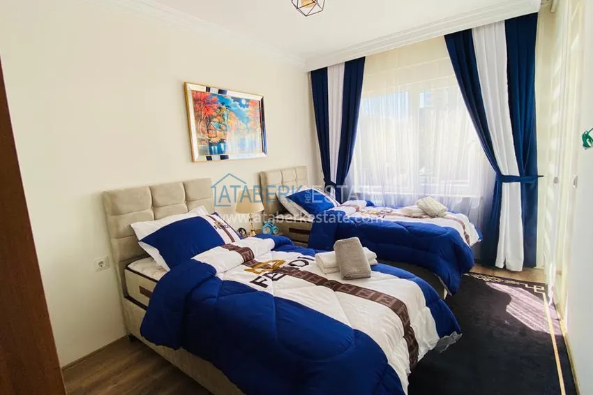 Приобрести Квартира в Махмутларе меблированная с отдельной кухней и видом на горы располагает собственной охраняемой территорией с инфраструктурой 17 