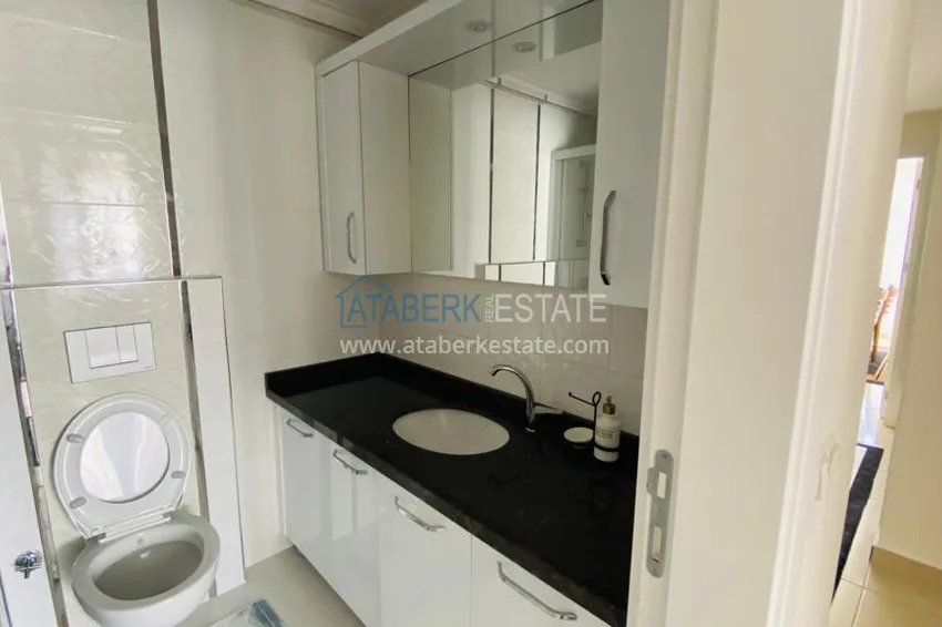 Приобрести Квартира в Махмутларе меблированная с отдельной кухней и видом на горы располагает собственной охраняемой территорией с инфраструктурой 18 