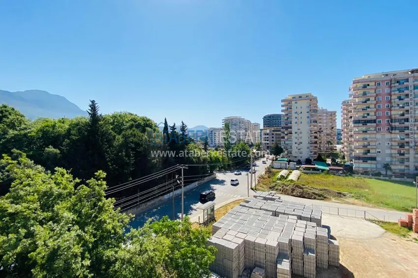 Приобрести Квартира в Махмутларе меблированная с отдельной кухней и видом на горы располагает собственной охраняемой территорией с инфраструктурой 23 