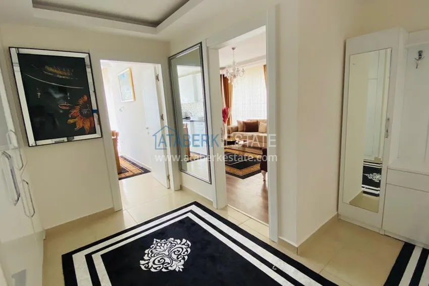 Приобрести Квартира в Махмутларе меблированная с отдельной кухней и видом на горы располагает собственной охраняемой территорией с инфраструктурой 4 