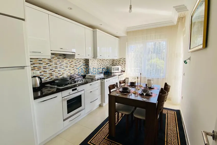 Приобрести Квартира в Махмутларе меблированная с отдельной кухней и видом на горы располагает собственной охраняемой территорией с инфраструктурой 11 