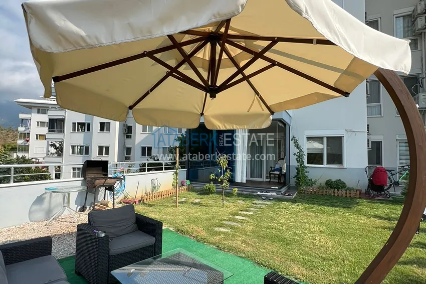 Приобрести Меблированная квартира с выходом в сад и видом на горы в Алании, район Оба в уютном жилом комплексе 12 