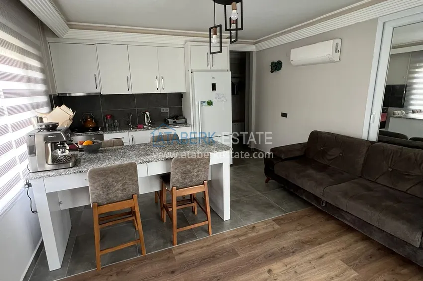 Приобрести Меблированная квартира с выходом в сад и видом на горы в Алании, район Оба в уютном жилом комплексе 2 