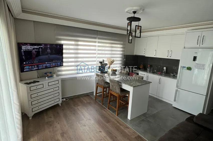 Приобрести Меблированная квартира с выходом в сад и видом на горы в Алании, район Оба в уютном жилом комплексе 4 