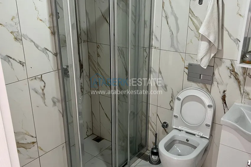 Приобрести Двухкомнатная квартира в Алании - район Оба в жилом доме городского типа 7 