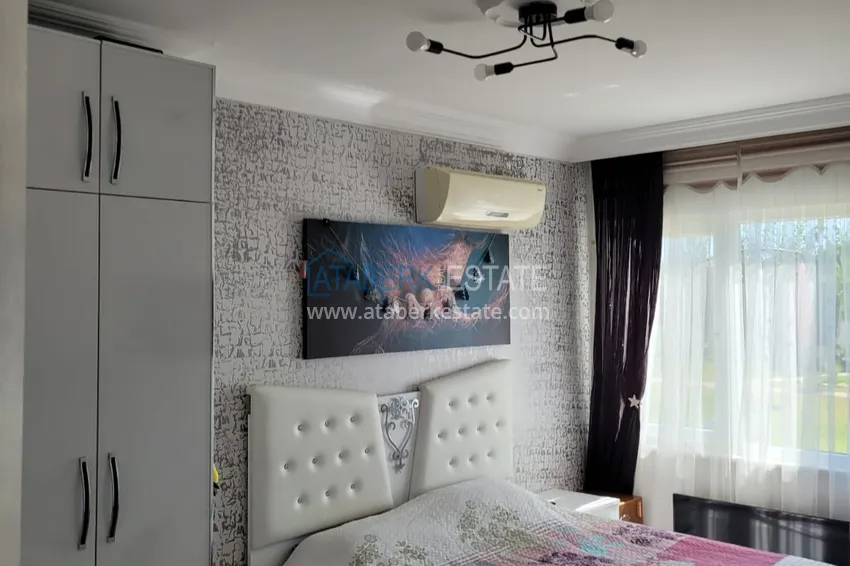 Приобрести Квартира с выходом в сад и застеклённым балконом в Оба в уютном жилом комплексе 11 