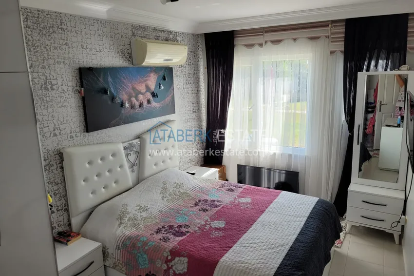 Приобрести Квартира с выходом в сад и застеклённым балконом в Оба в уютном жилом комплексе 9 