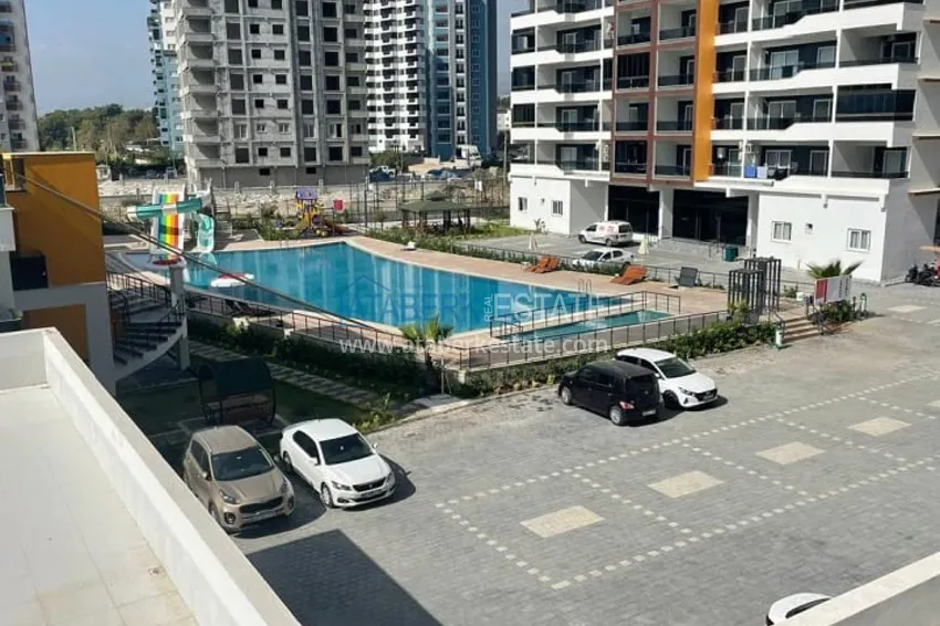 Квартира 2+1 с чистовой отделкой, в новом ЖК с инфраструктурой, в районе Арпачбахшиш-Мерсин 2 