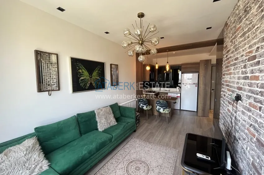 Приобрести Апартаменты 1+1 с мебелью и техникой, частично вид на море в районе Мезитли-Мерсин 2 