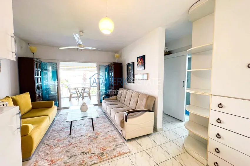 Приобрести Просторная двухкомнатная квартира с мебелью и камином в районе Алании – Конаклы 6 