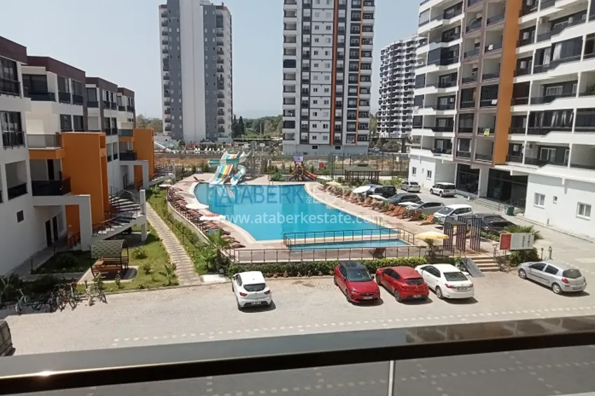 Приобрести Квартира 1+1 в молодом комплексе в 350 метрах от моря Арпачбахшиш – Мерсин 14 