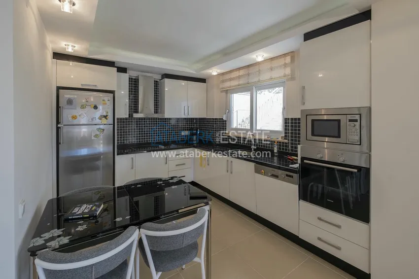 Приобрести Меблированный садовый дуплекс с двумя спальнями, застекленным балконом и видом на море в Алании 21 