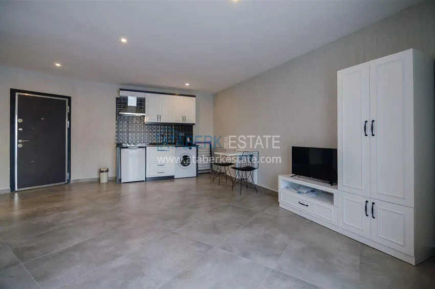 Приобрести Квартира-студия с мебелью и боковым видом на море в Алании, район Каргыджак 2 