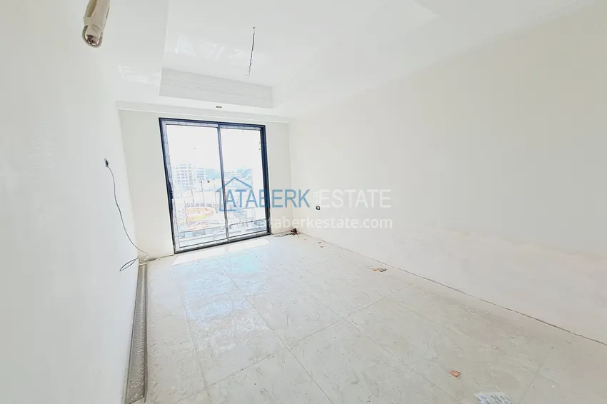 Приобрести Двухкомнатная квартира 85 м2 в строящемся комплекс-отеле в Алании, район Тюрклер 5 