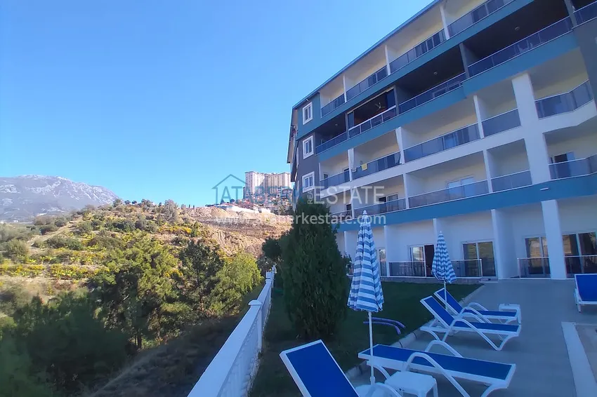 Квартира-студия с мебелью и боковым видом на море в Алании, район Каргыджак 7 