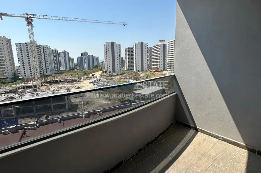 Приобрести Двухкомнатная квартира в Мерсине, район Арпачбахшиш в 300 метрах от моря 11 