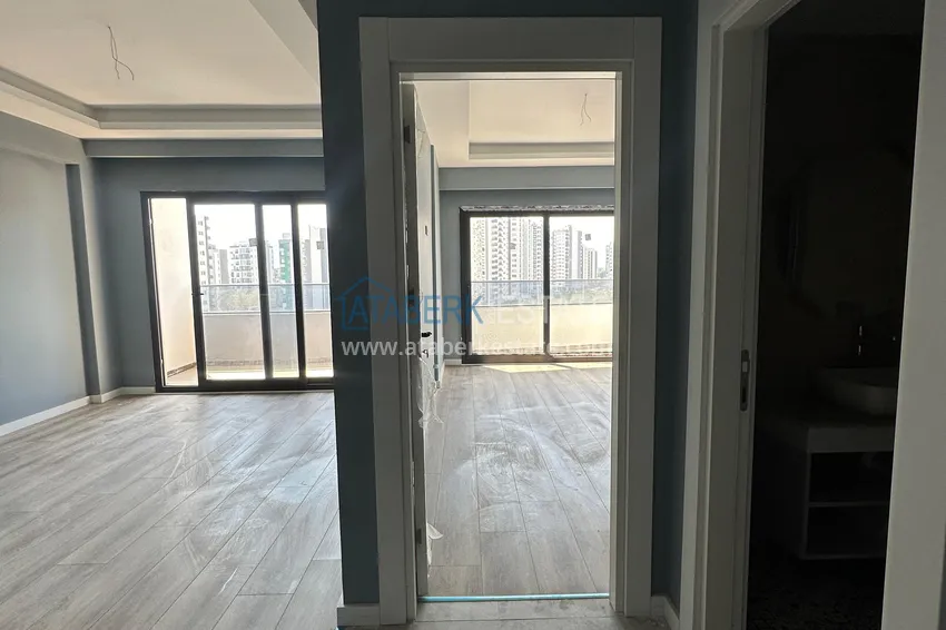 Приобрести Двухкомнатная квартира в Мерсине, район Арпачбахшиш в 300 метрах от моря 1 