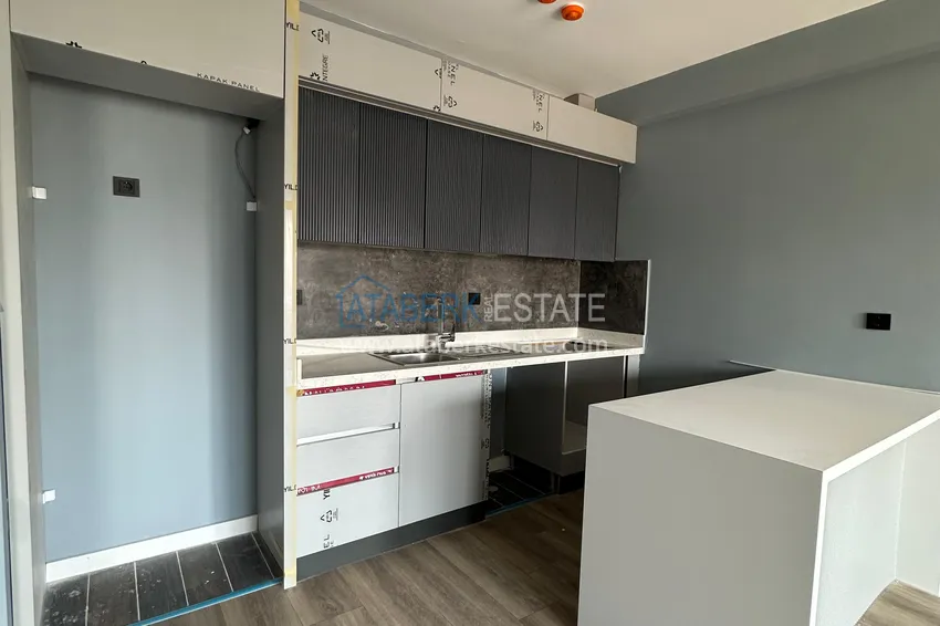 Приобрести Двухкомнатная квартира в Мерсине, район Арпачбахшиш в 300 метрах от моря 3 