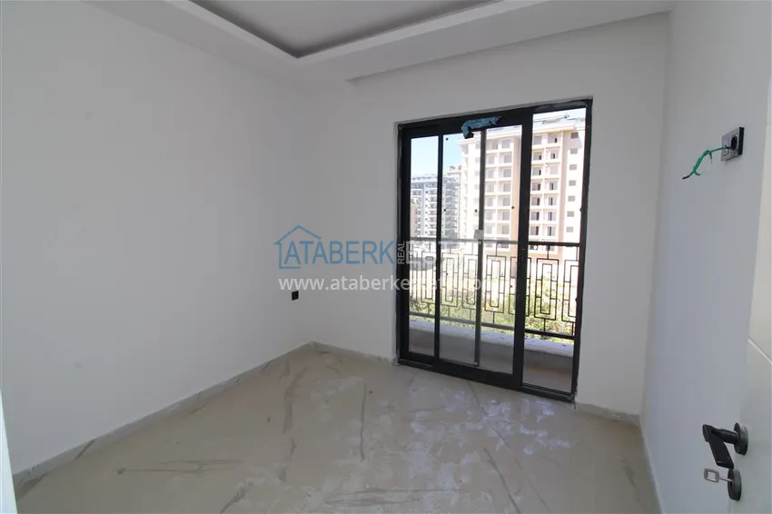 Приобрести Двухкомнатные квартиры с чистовой отделкой в районе Махмутлар, Алания 6 