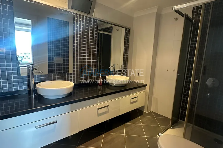 Приобрести Трехкомнатная квартира с мебелью и панорамным видом в районе Джикджилли Алания 12 