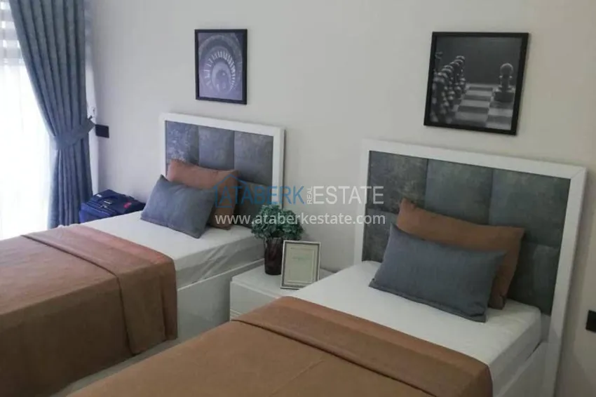 Приобрести Трехкомнатная квартира с панорамным видом на море и горы в центре Махмутлара 10 