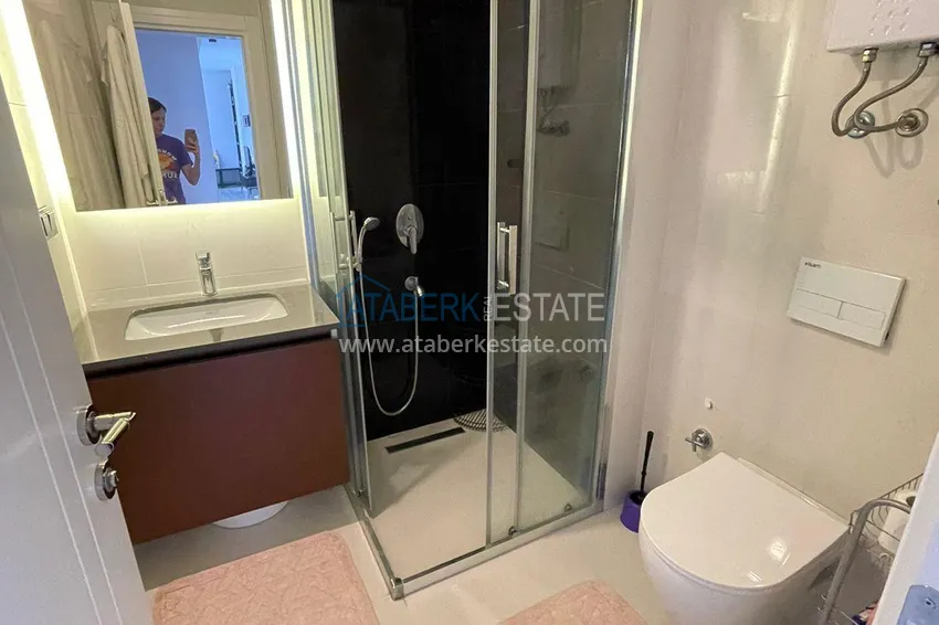 Приобрести Трехкомнатная квартира с панорамным видом на море и горы в центре Махмутлара 11 