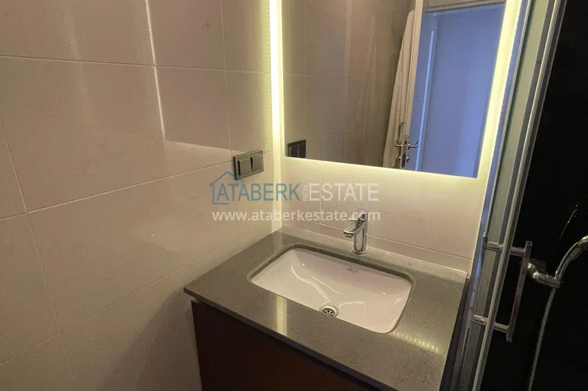 Приобрести Трехкомнатная квартира с панорамным видом на море и горы в центре Махмутлара 12 