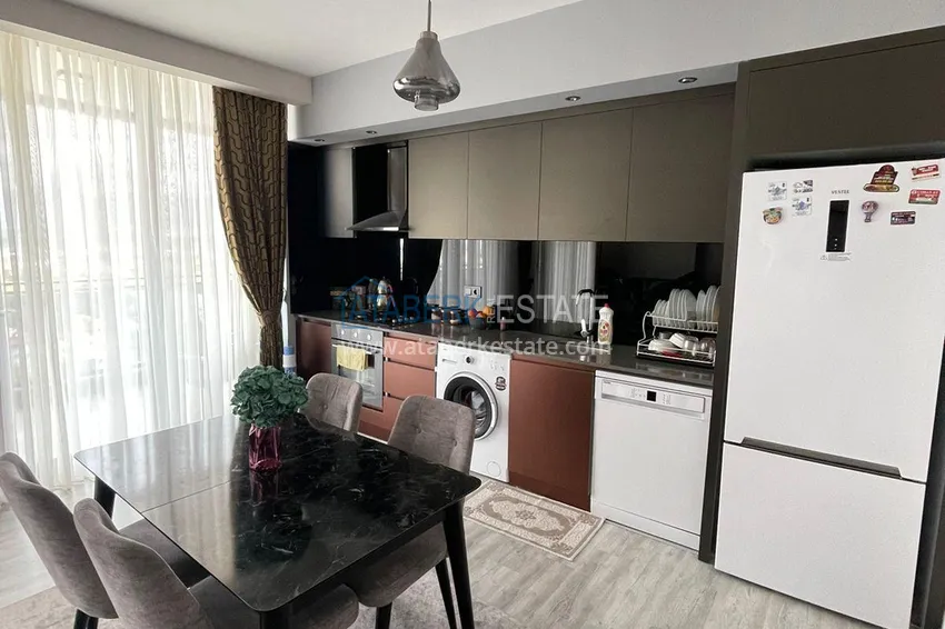 Приобрести Трехкомнатная квартира с панорамным видом на море и горы в центре Махмутлара 6 