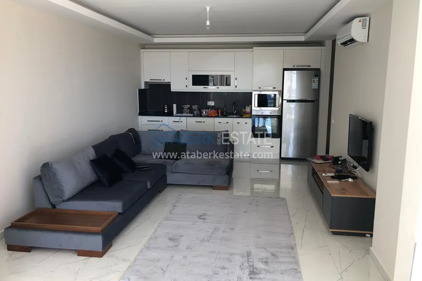 Приобрести Квартира 2+1 с террасой 70 м² в Алании, район Махмутлар - с мебелью и видом на море  1 